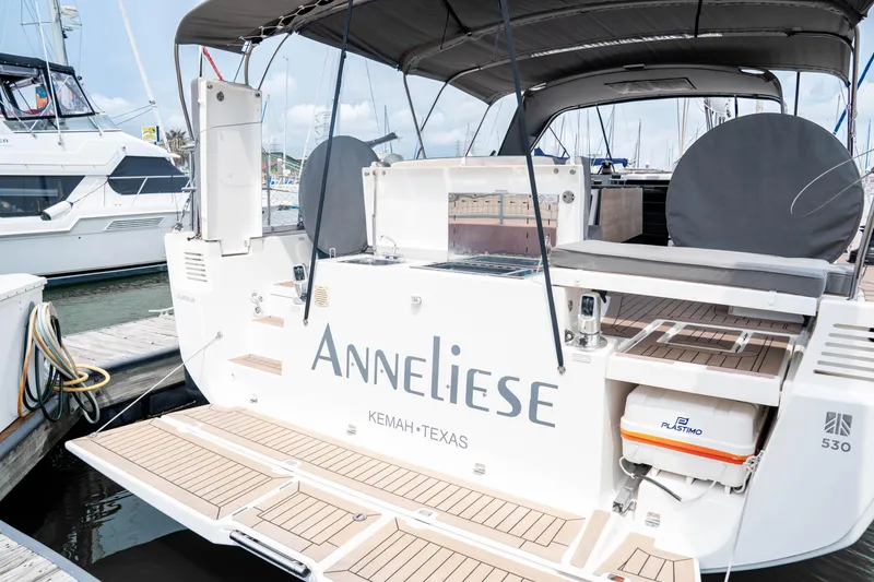 Slide: The Image of 2023 Dufour 530 yacht docked, featuring spacious deck and modern amenities. - 6