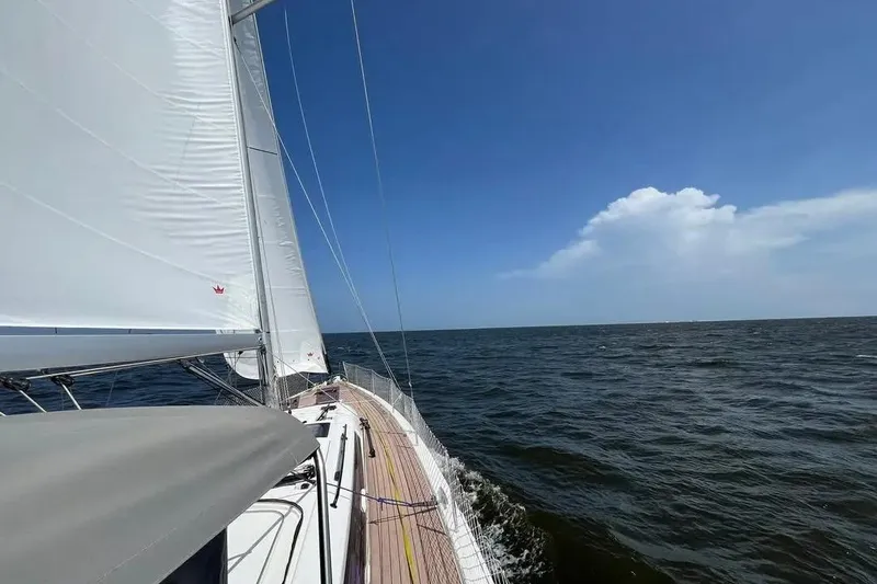 Slide: The Image of Sailing on a 2023 Dufour 530 yacht under clear blue skies. - 7