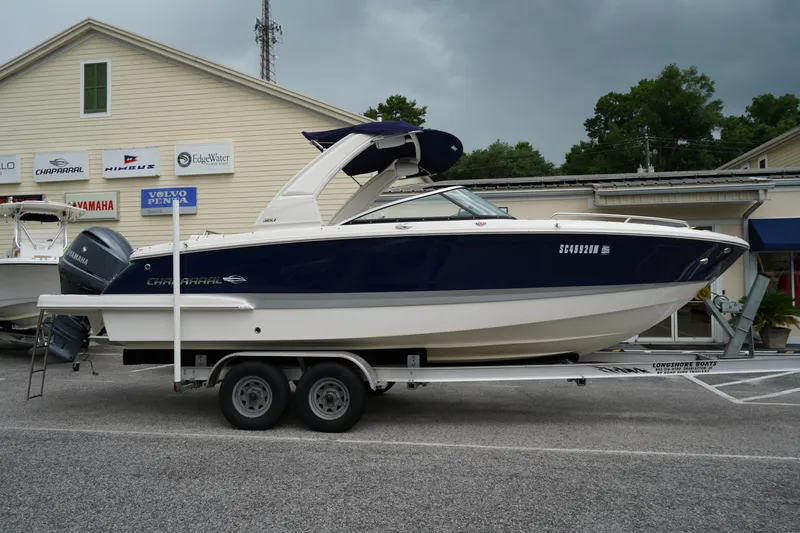 The Image of 2020 Chaparral 257 SSX boat on trailer, parked outside dealership. - 0