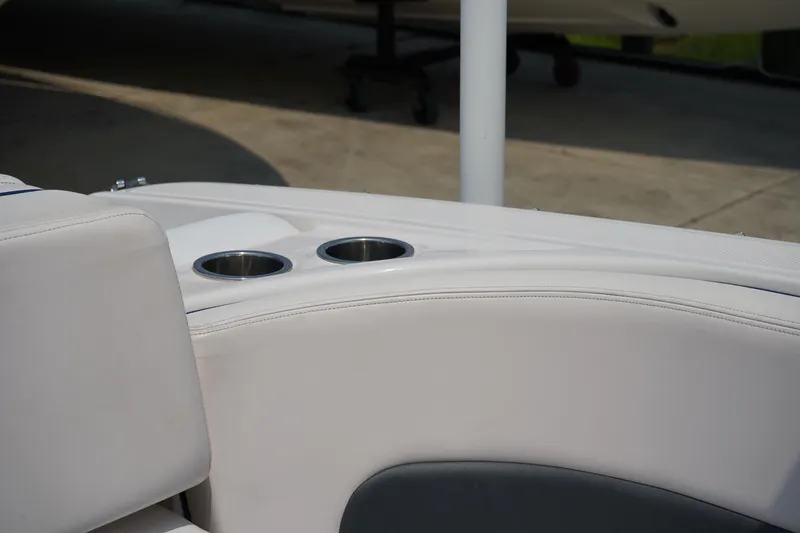 Slide: The Image of 2020 Chaparral 257 SSX boat interior with cup holders and white seating. - 12