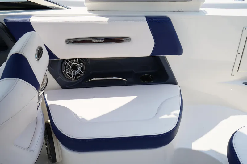 Slide: The Image of 2020 Chaparral 257 SSX boat interior with white and blue seating and speaker. - 13