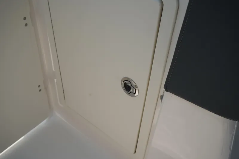 Slide: The Image of 2020 Chaparral 257 SSX boat storage compartment with sleek design and secure latch. - 24