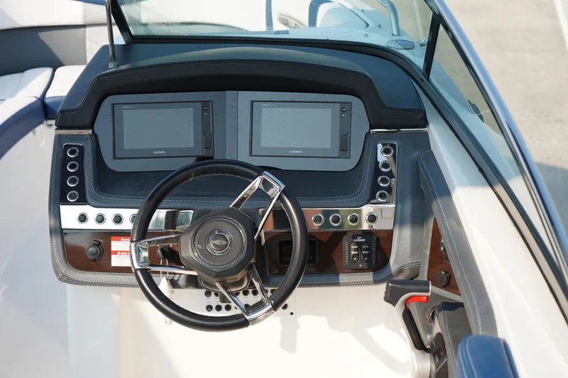 Slide: The Image of 2020 Chaparral 257 SSX boat dashboard with dual screens and steering wheel. - 28