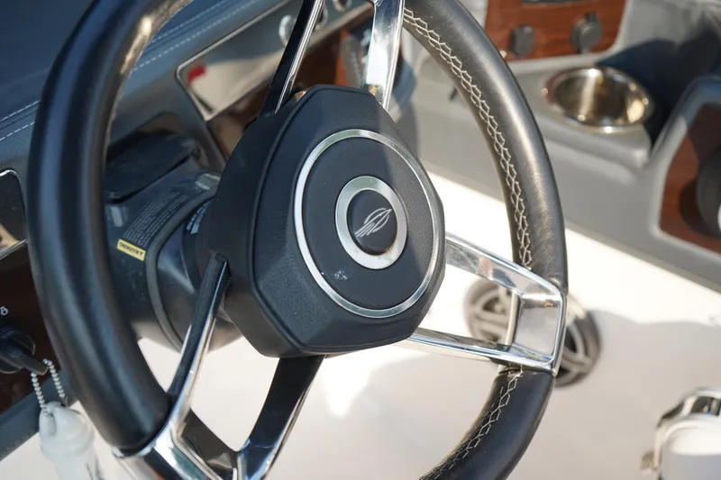 Slide: The Image of Steering wheel of 2020 Chaparral 257 SSX boat, featuring sleek design and stitching detail. - 29