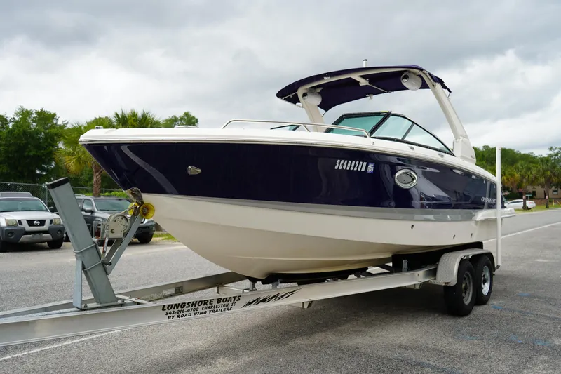 Slide: The Image of 2020 Chaparral 257 SSX boat on trailer, parked outdoors under cloudy sky. - 3