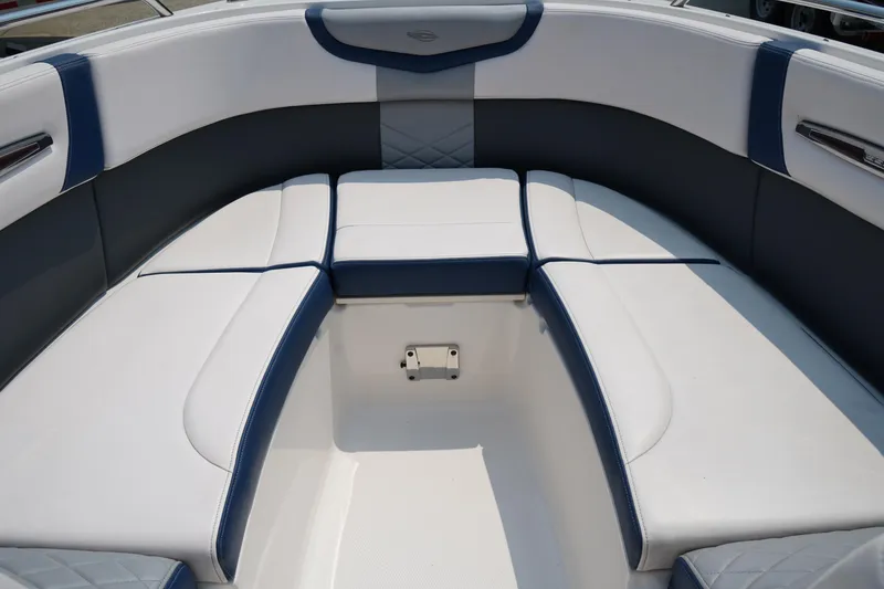 Slide: The Image of 2020 Chaparral 257 SSX boat interior with white and blue cushioned seating. - 33