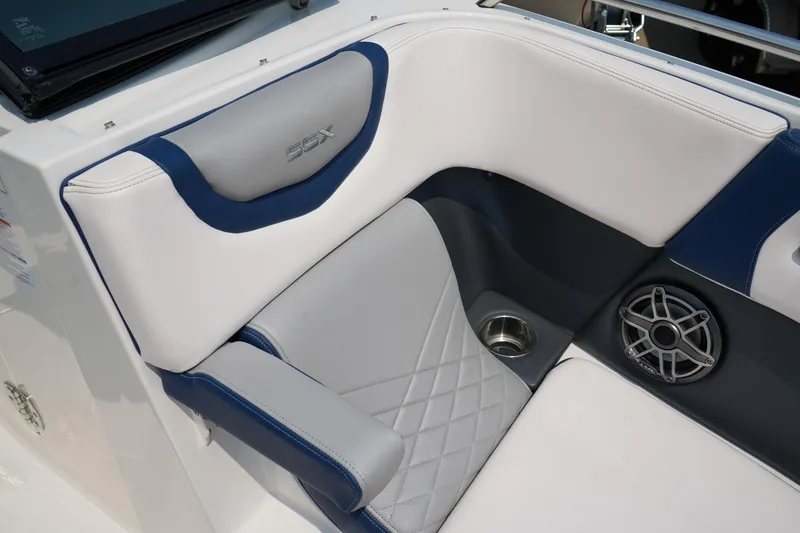 Slide: The Image of 2020 Chaparral 257 SSX boat interior with white and blue seating, speaker, and cup holder. - 36