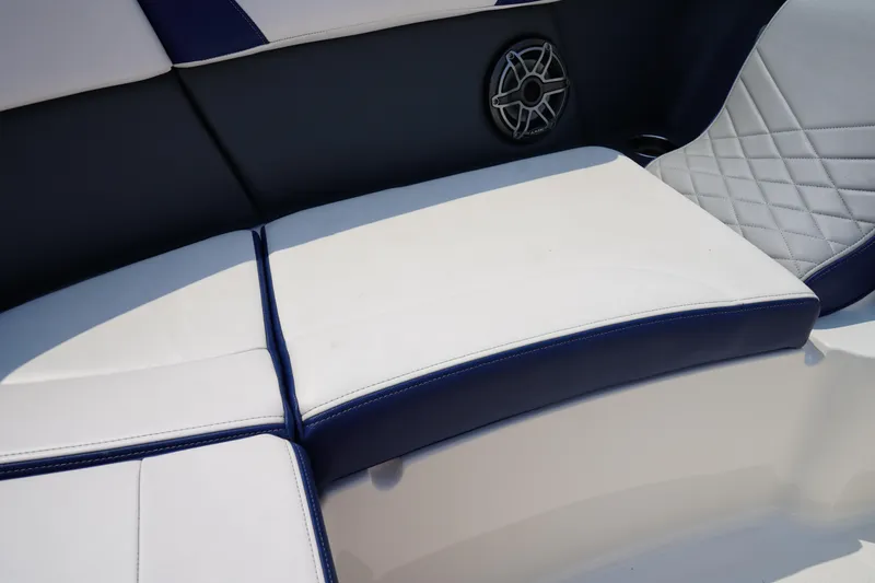 Slide: The Image of 2020 Chaparral 257 SSX boat interior with white and navy seating, speaker detail. - 37