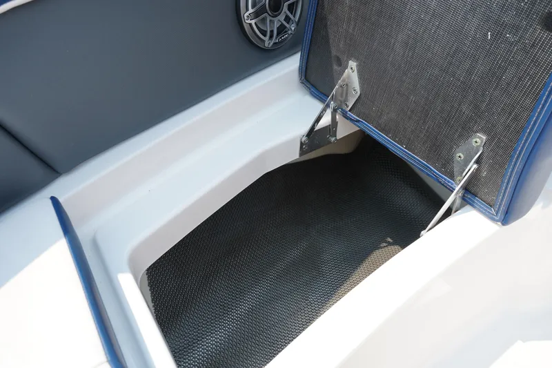 Slide: The Image of Open storage compartment in 2020 Chaparral 257 SSX boat, featuring durable interior lining. - 38