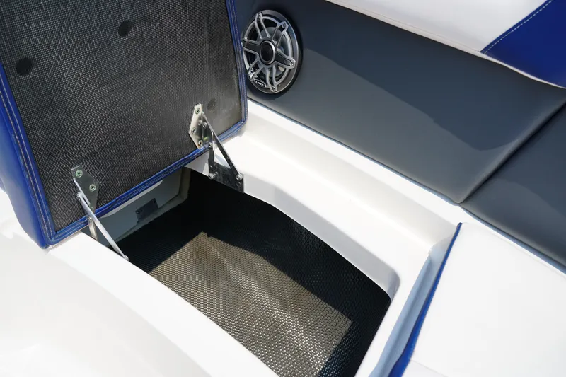 Slide: The Image of 2020 Chaparral 257 SSX boat storage compartment with open lid and speaker detail. - 39