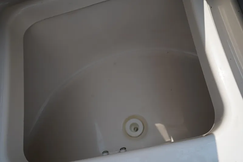 Slide: The Image of Storage compartment in 2020 Chaparral 257 SSX boat, featuring a clean, white interior. - 40