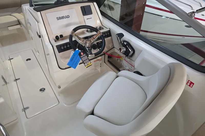 Slide: The Image of 2026 Boston Whaler 240 Vantage boat cockpit with steering wheel and control panel. - 4