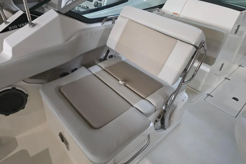 Slide: The Image of 2026 Boston Whaler 240 Vantage boat interior seating with beige and white upholstery. - 9