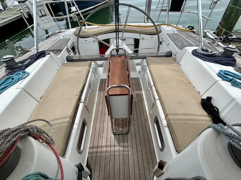Slide: The Image of Cockpit of 2003 Beneteau First 47.7 sailboat with teak flooring and seating. - 11