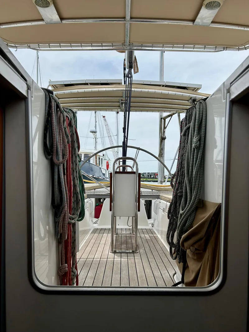 Slide: The Image of Beneteau First 47.7 sailboat cockpit, 2003 model, with ropes and steering wheel visible. - 12