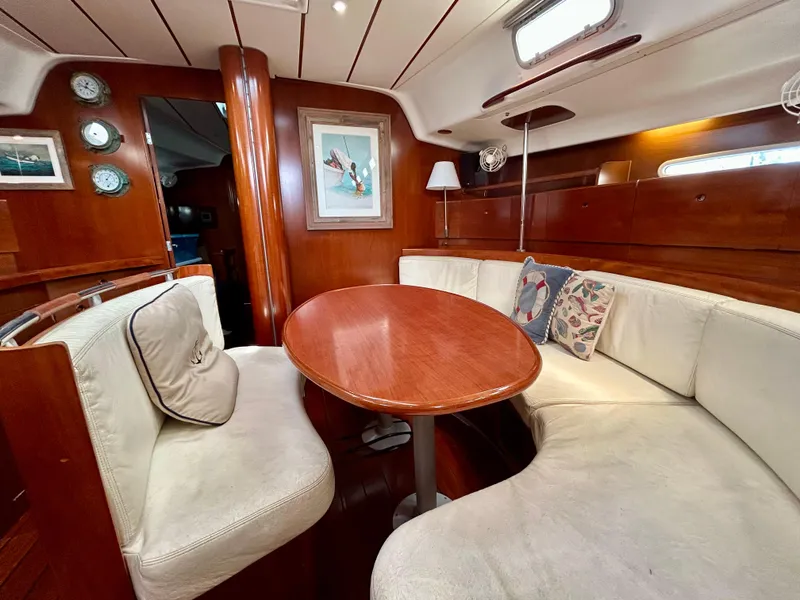 Slide: The Image of Interior of 2003 Beneteau First 47.7 yacht with cozy seating and wooden table. - 15