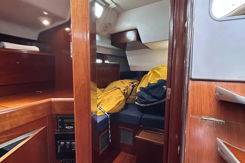 Slide: The Image of Cabin interior of 2003 Beneteau First 47.7 sailboat with wooden finish and cozy sleeping area. - 28