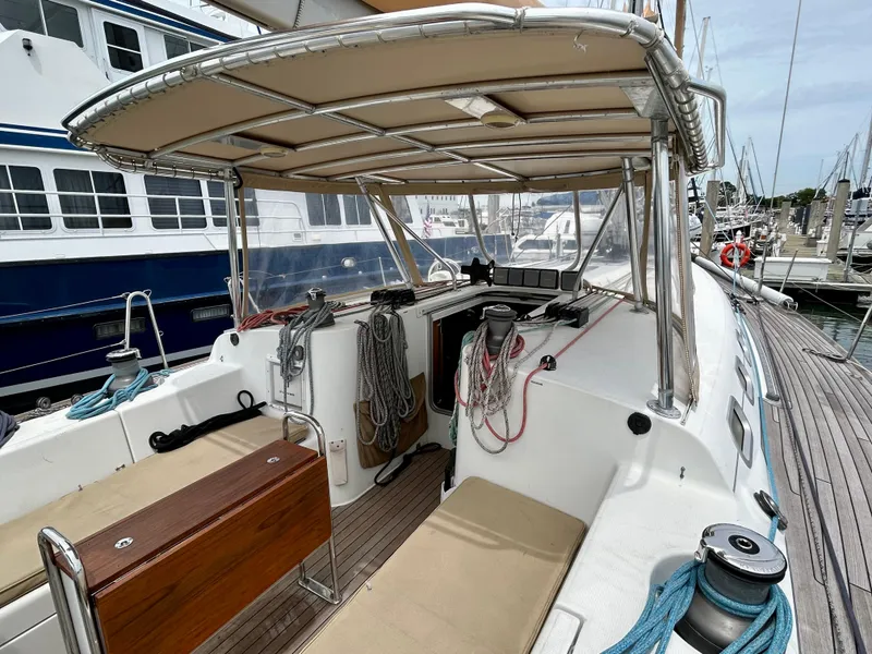 Slide: The Image of Beneteau First 47.7 sailboat cockpit, 2003 model, docked at marina with canopy and seating. - 7