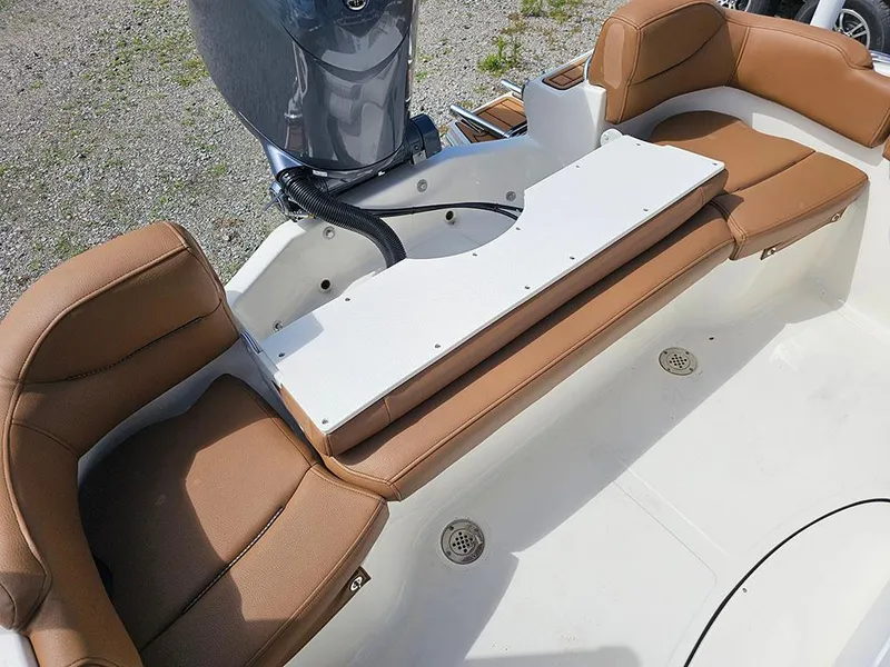 Slide: The Image of 2025 Pioneer 202 Islander boat interior with tan seating and motor. - 11