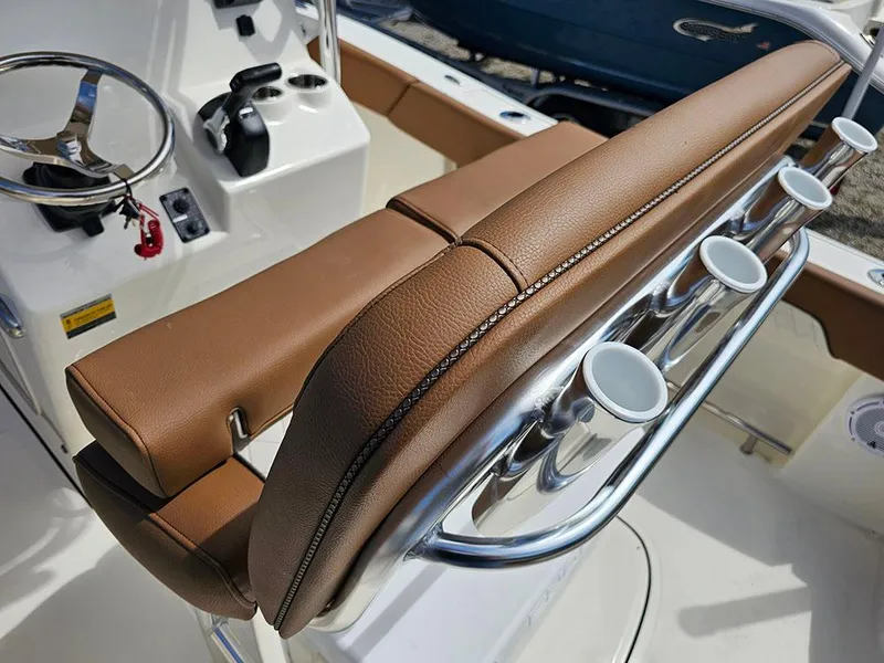 Slide: The Image of 2025 Pioneer 202 Islander boat helm with brown seating and rod holders. - 14