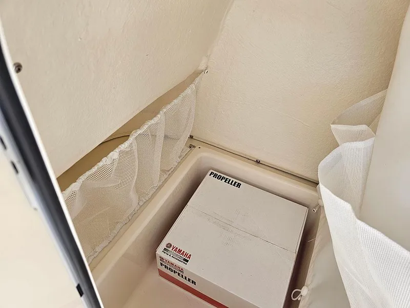 Slide: The Image of Box labeled "Yamaha Propeller" inside 2025 Pioneer 202 Islander boat storage compartment. - 21