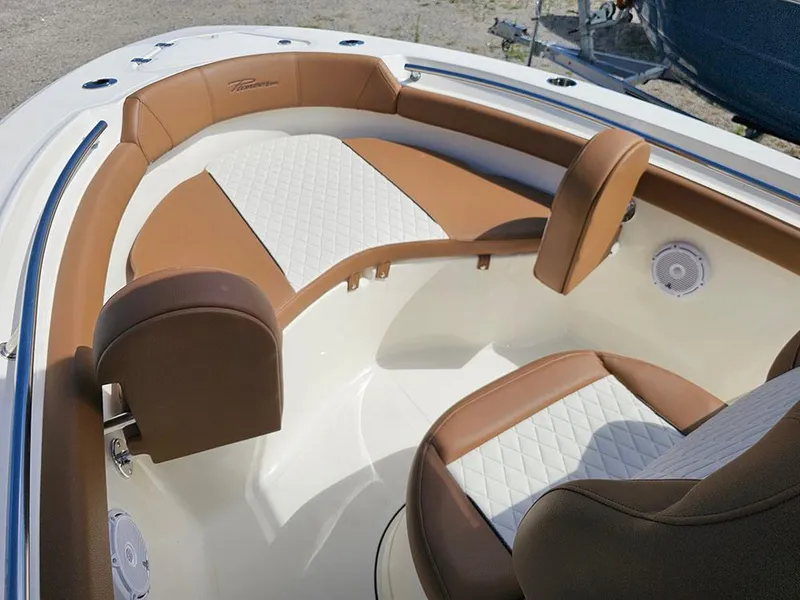 Slide: The Image of 2025 Pioneer 202 Islander boat interior with brown and white cushioned seating. - 22