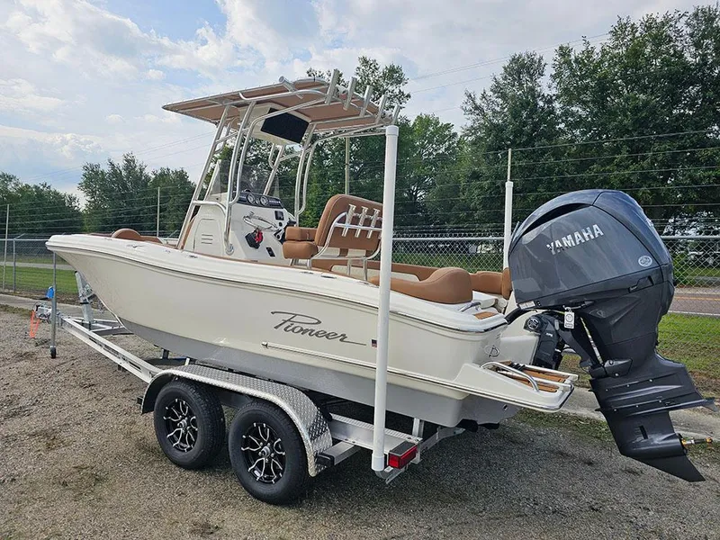 Slide: The Image of 2025 Pioneer 202 Islander boat on trailer with Yamaha outboard motor, parked outdoors. - 3