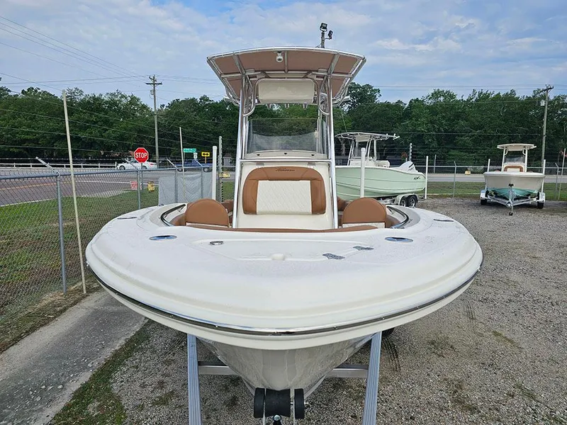 Slide: The Image of 2025 Pioneer 202 Islander boat displayed outdoors, front view, with seating and canopy. - 4