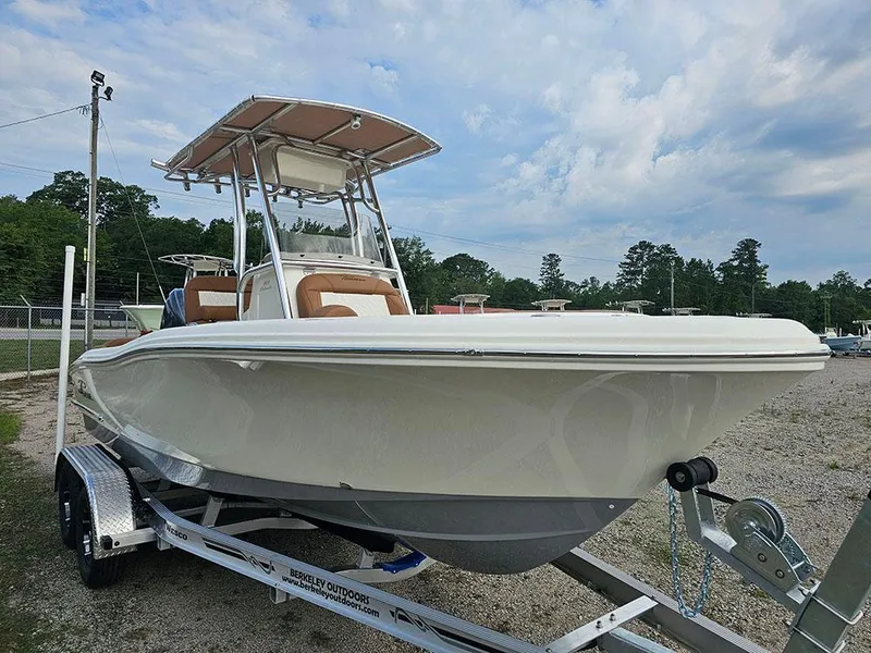 Slide: The Image of 2025 Pioneer 202 Islander boat on trailer, parked outdoors under cloudy sky. - 5