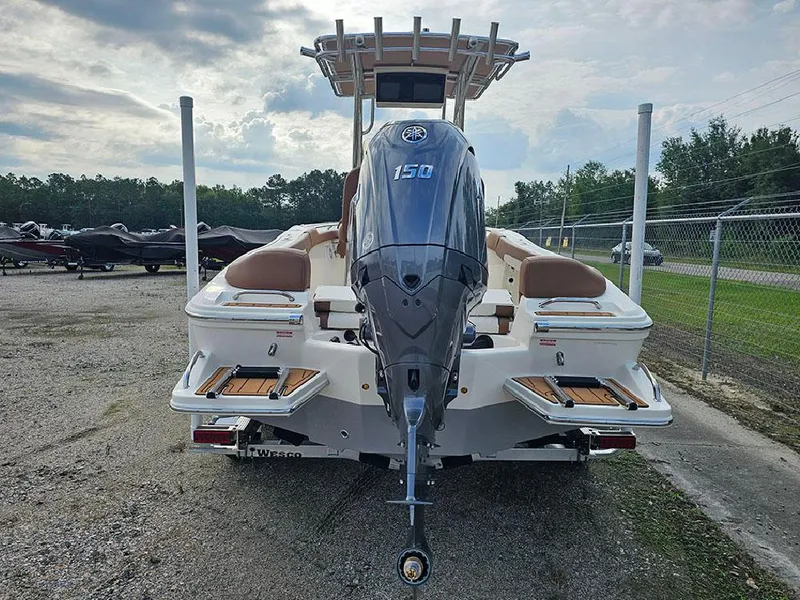 Slide: The Image of 2025 Pioneer 202 Islander boat with powerful outboard motor, parked outdoors. - 7
