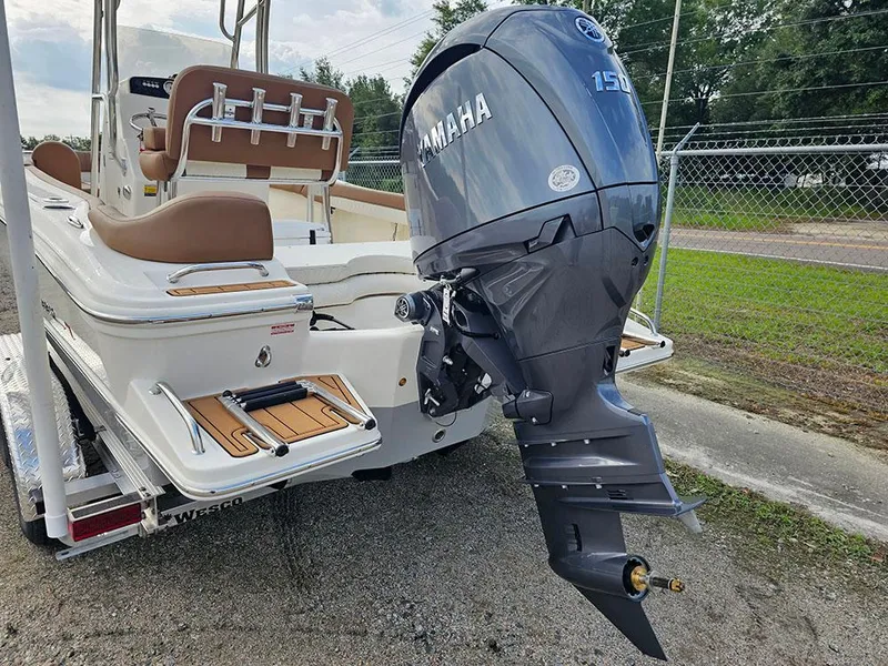 Slide: The Image of 2025 Pioneer 202 Islander boat with Yamaha 150 engine, parked on a trailer. - 8