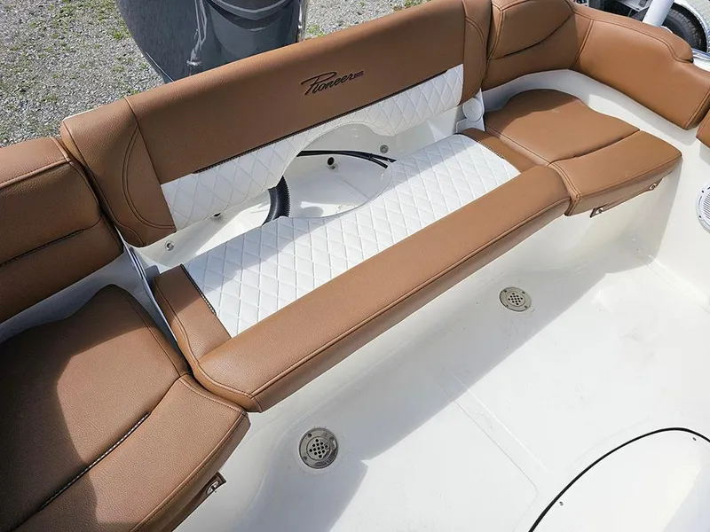 Slide: The Image of 2025 Pioneer 202 Islander boat interior with brown and white cushioned seating. - 9