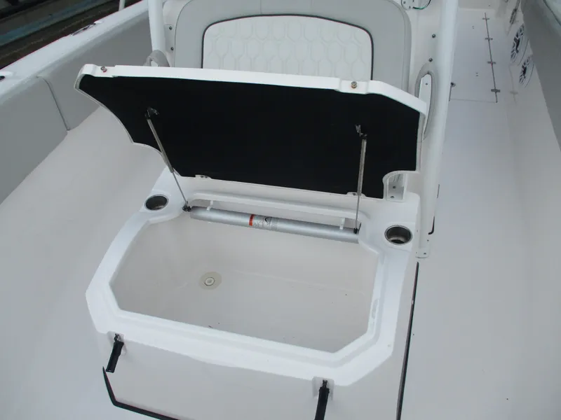 Slide: The Image of 2022 Sea Fox 288 Commander boat storage compartment with open lid and cup holders. - 6