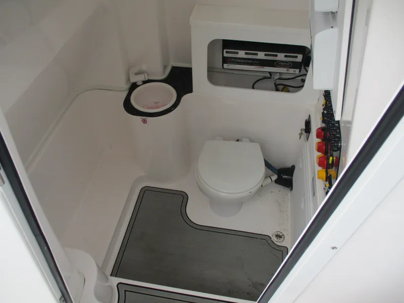 Slide: The Image of 2022 Sea Fox 288 Commander boat bathroom with toilet and control panel. - 8