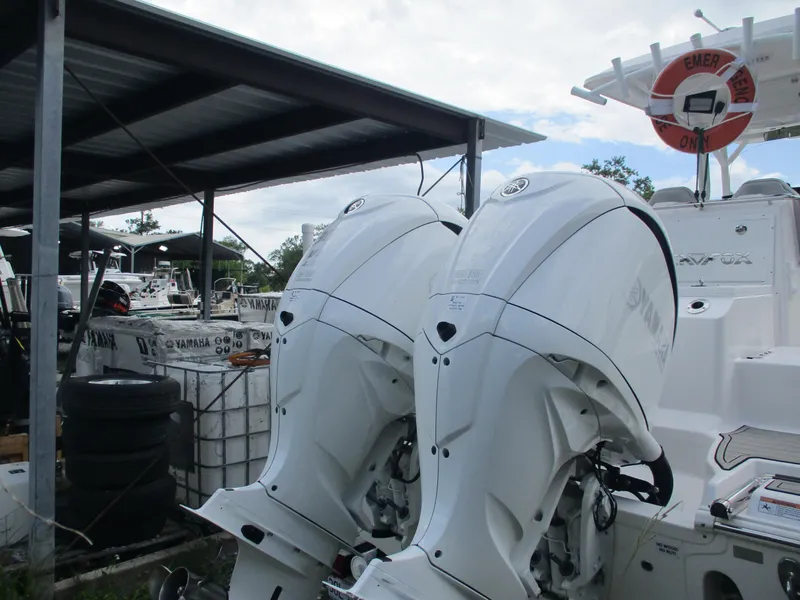 Slide: The Image of 2022 Sea Fox 288 Commander with dual outboard engines in a marina setting. - 9