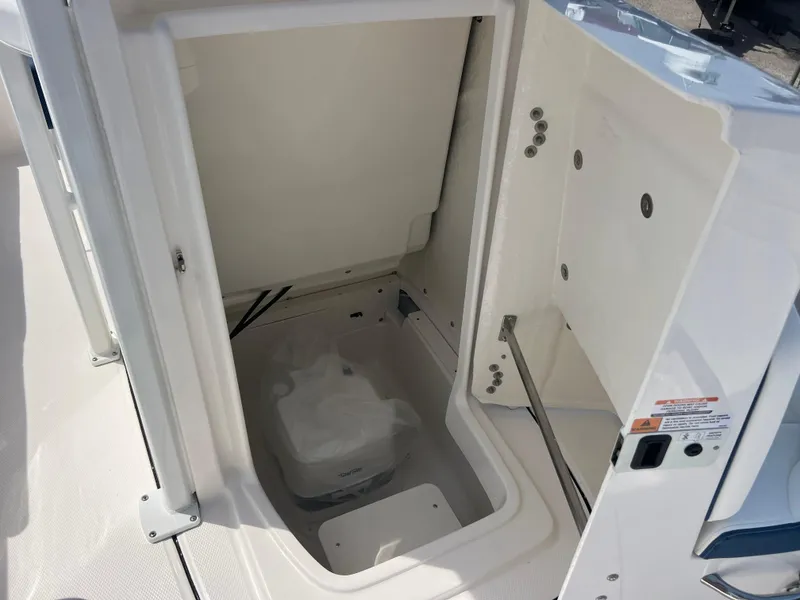 Slide: The Image of 2025 Robalo 226 Cayman boat storage compartment, open and empty, showcasing interior space. - 13