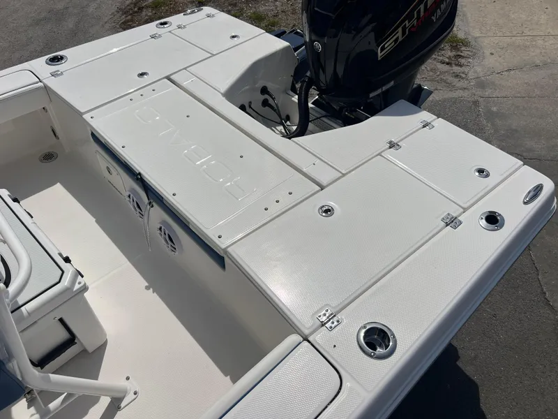 Slide: The Image of 2025 Robalo 226 Cayman boat deck with storage compartments and outboard motor. - 15