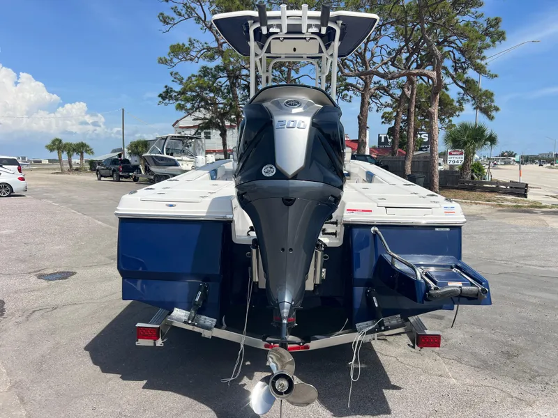 Slide: The Image of 2025 Robalo 226 Cayman boat with powerful outboard motor, parked outdoors. - 5