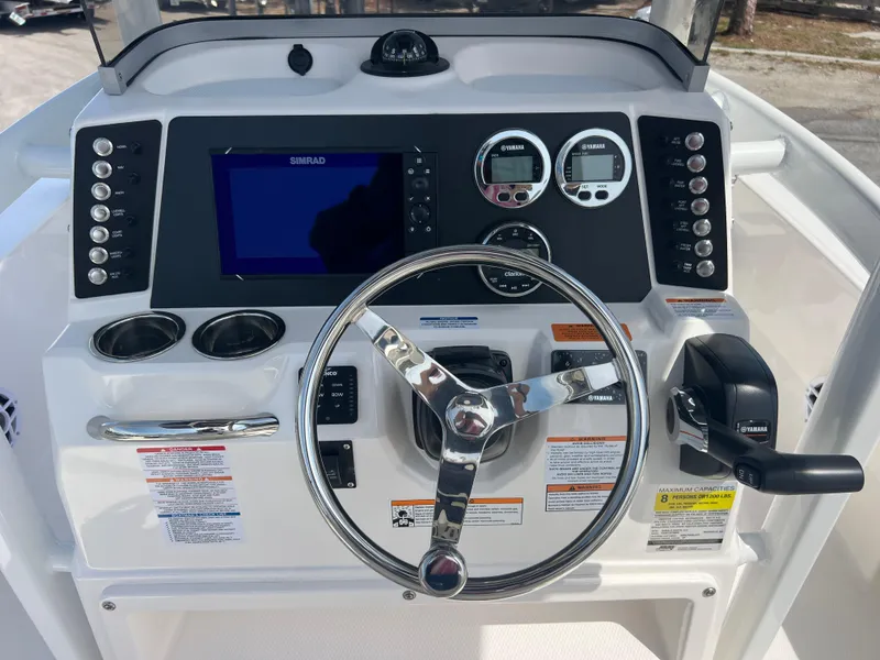 Slide: The Image of 2025 Robalo 226 Cayman boat dashboard with steering wheel and control panel. - 9