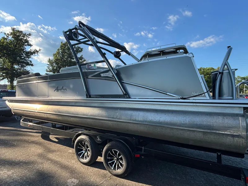 The Image of 2021 Avalon Catalina Entertainer 25' pontoon boat on trailer, sunny day, trees in background. - 0