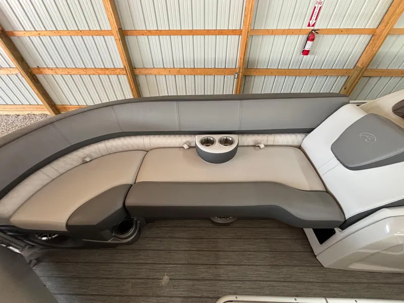 Slide: The Image of 2021 Avalon Catalina Entertainer 25' boat interior with gray seating and cup holders. - 12