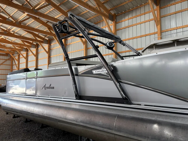 Slide: The Image of 2021 Avalon Catalina Entertainer 25' pontoon boat in a wooden storage facility. - 18