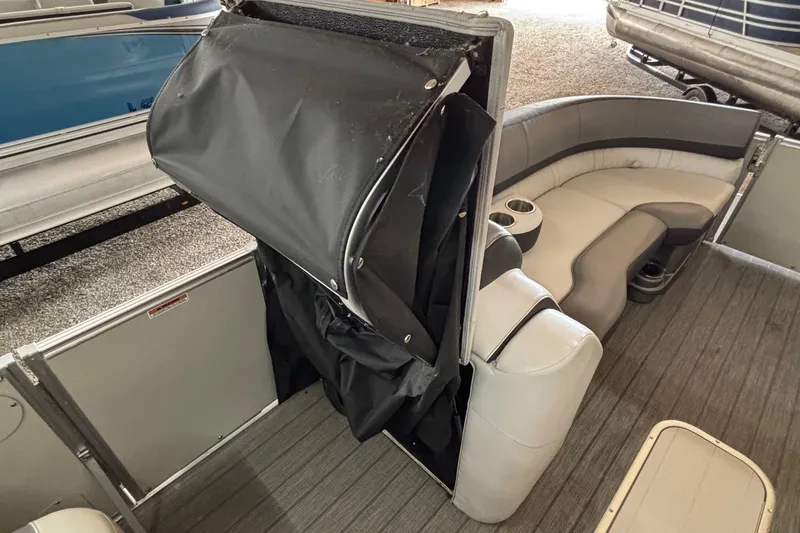 Slide: The Image of 2021 Avalon Catalina Entertainer 25' boat interior with seating and storage area. - 22