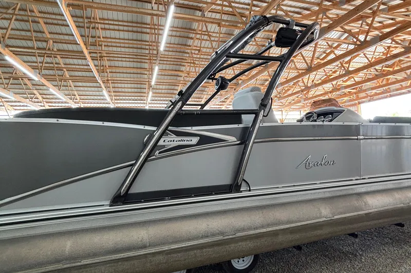 Slide: The Image of 2021 Avalon Catalina Entertainer 25' pontoon boat in a covered storage area. - 23