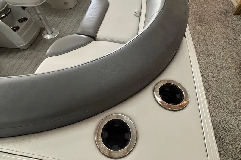 Slide: The Image of 2021 Avalon Catalina Entertainer boat interior with cushioned seating and cup holders. - 25