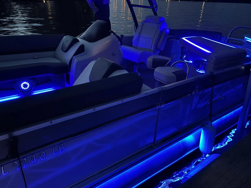 Slide: The Image of 2021 Avalon Catalina Entertainer boat with blue LED lights at night. - 5