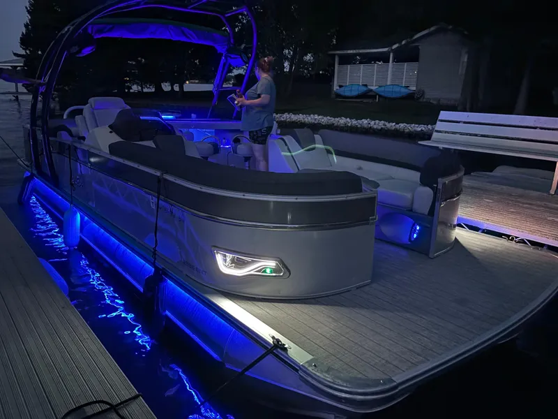 Slide: The Image of 2021 Avalon Catalina Entertainer pontoon boat with blue LED lights at dock. - 6