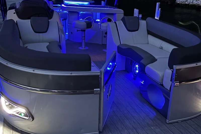 Slide: The Image of Luxurious 2021 Avalon Catalina Entertainer boat interior with blue LED lighting and plush seating. - 7