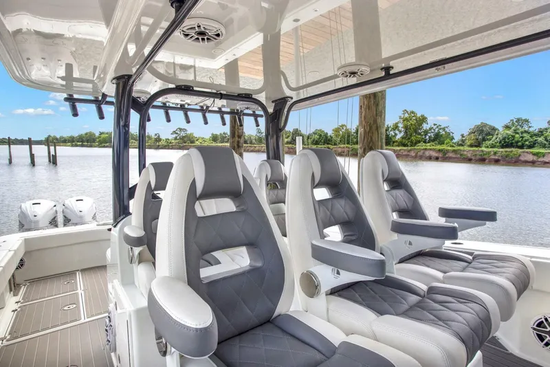 Slide: The Image of Luxurious seating on a 2022 Freeman 47T boat with scenic river backdrop. - 18