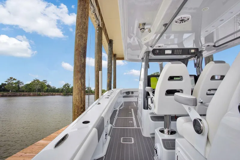 Slide: The Image of 2022 Freeman 47T boat interior with sleek seating and modern design by the water. - 23